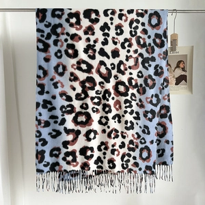 Detail of leopard print scarf with colorful gradient patterns and fine fringe tassels