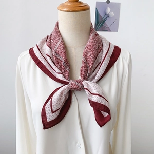 Bohemian style red and white silk scarf tied in a bow on a white shirt collar