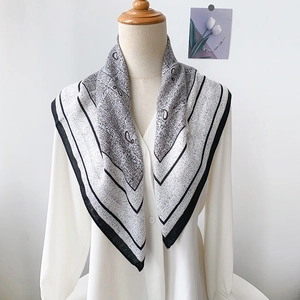 Bohemian paisley silk scarf with vintage letter print on a mannequin with white shirt