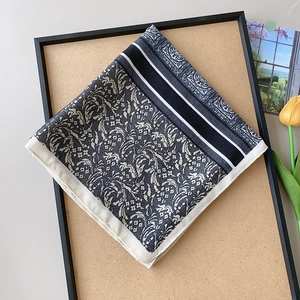 Elegant navy blue and beige floral square scarf styled with tulips and a vintage postcard