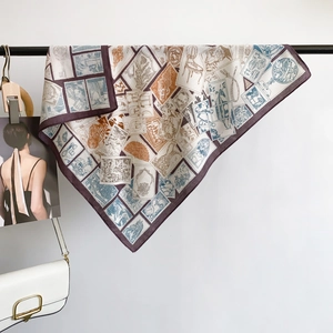 Elegant vintage stamp print silk scarf with purple border hanging next to a white bag