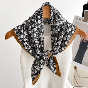 Floral silk-feel headscarf with brown borders styled on a white knitted vest