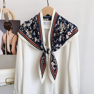 Floral navy blue silk scarf for women styled with a white shirt on a hanger