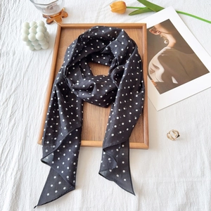 French style black and white polka dot silk scarf in an elegant lifestyle setting