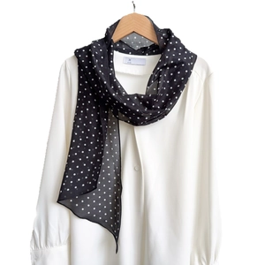 French style black silk scarf with white polka dots on a wooden hanger with white shirt