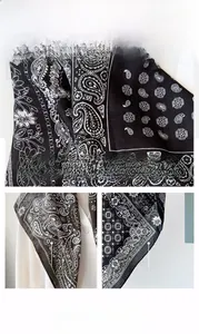 Detail of black paisley scarf featuring herringbone texture and refined hem stitching