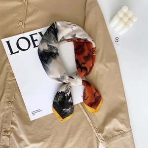 Elegant crane velvet silk scarf with abstract print on khaki cotton shirt background