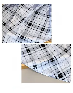 Détail macro du foulard en soie montrant le motif à carreaux et l'ourlet roulé