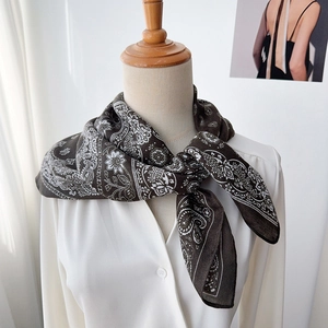 Classic black paisley silk scarf for women elegantly tied over a white shirt