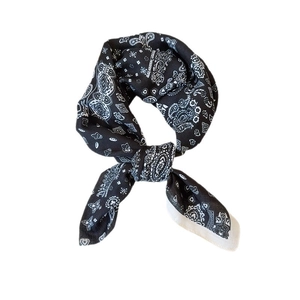Classic black and white paisley print square scarf tied in a stylish knot