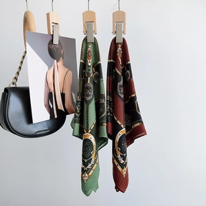 Detail of vintage equestrian print silk scarf with green and burgundy baroque motifs