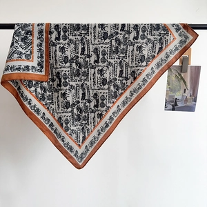 Elegant carriage pattern square scarf with orange border and silky finish on hanger