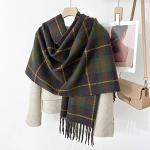 Detail of vintage plaid tassel scarf showing dark purple and green thick cashmere texture