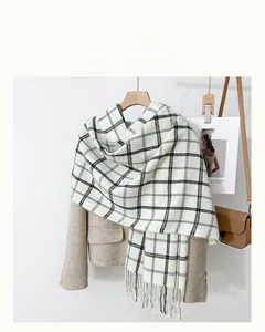 Classic black and white plaid scarf with fringe paired with a beige woolen coat for winter