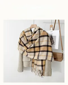 Detail of British plaid scarf with long tassels and thick winter cashmere-like texture