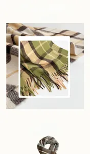 Close-up of British plaid faux cashmere scarf texture with classic fringe details