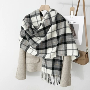 Detail of classic plaid scarf with tassel hem and soft cashmere-like texture fabric
