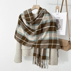 Detail of soft thick cashmere-like plaid scarf with fringe tassels in coffee blue white