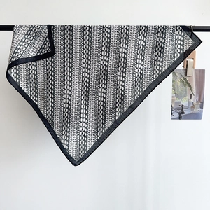 Elegant herringbone silk-feel square scarf with classic black and white geometric patterns