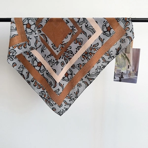 Detail of herringbone cotton linen scarf with geometric blocks and black lace floral prints