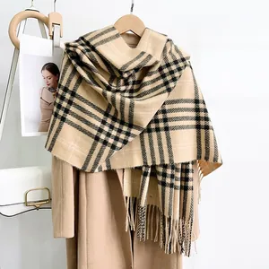 Detail view of British style checkered cashmere scarf with classic tassel fringes