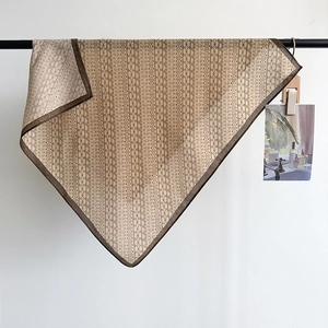 Beige herringbone silk feel scarf with geometric plant patterns and dark brown edges