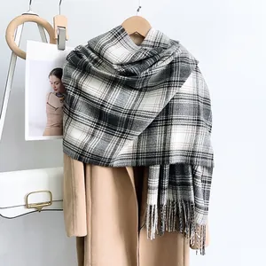 Detail of classic plaid scarf with thick fringe and soft cashmere-like texture fabric