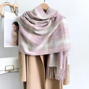 Pink and grey plaid cashmere-like scarf with fringe, styled on a wool coat for winter fashion
