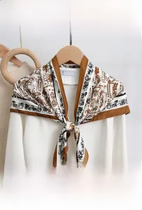 Detail of Korean-style triangular silk scarf with vintage carriage print in coffee and black