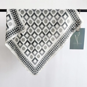 Elegant checkerboard silk scarf with camellia floral patterns and houndstooth edge