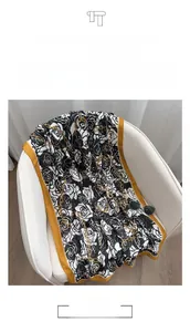 Detail of high quality cotton-linen scarf with black and white rose print and gold border