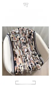 Detail of soft linen-cotton shawl with earthy geometric patterns and dark floral motifs