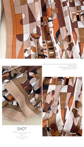 Detail of soft earth-tone scarf showing abstract geometric patterns and silky texture