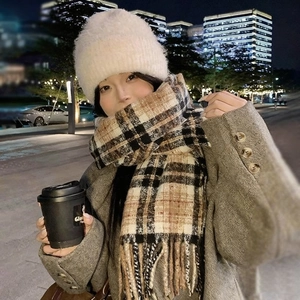 Plush white earflap hat and classic plaid tassel scarf for winter warmth