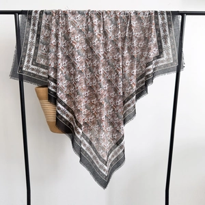 Close-up detail of bohemian thistle print shawl with delicate tassel fringe edges