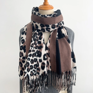 Vintage leopard print winter scarf with tassels shown on a mannequin with gray cardigan