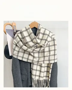 Detailed view of plaid scarf fringe and thick checkered cashmere-like fabric texture