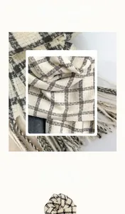 Close-up of premium cashmere-like fabric showing soft texture of plaid scarf