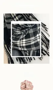 Close-up of soft plaid pattern texture and delicate tassel details on a warm winter scarf