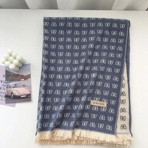 Gray-blue thick knit scarf with white butterfly jacquard patterns and long fringes