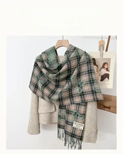 Detail shot of multicolor plaid wool scarf with soft tassels and woven texture