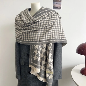 Thick warm houndstooth scarf with tassels on mannequin with grey coat
