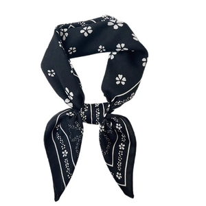 Elegant black silk neckerchief with white floral print tied in a stylish bow knot
