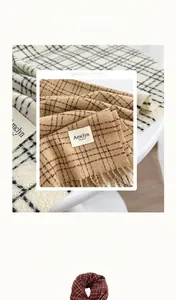 Detail of soft imitation cashmere scarf with plaid texture and decorative fringes