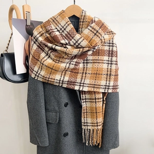 Cozy plaid scarf with tassels in brown and yellow, styled on a classic wool coat