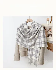Détail d'une écharpe à carreaux douce avec franges sur un manteau dans un cadre chaleureux
