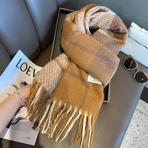 Checkered plaid knit scarf in brown and cream colors with fringe detail for winter warmth
