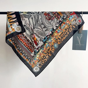 Detail of elegant leopard print silk scarf showing smooth texture and exotic patterns