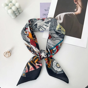 Detailed view of luxury silk scarf tied in a stylish knot with vibrant artistic patterns
