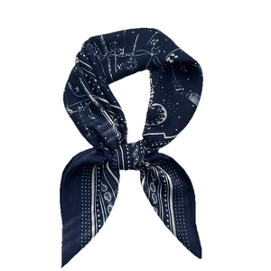 Navy blue paisley silk scarf with white astrological patterns and knot styling